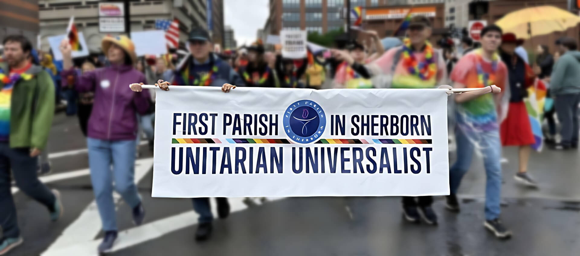 People walking down street carrying banner